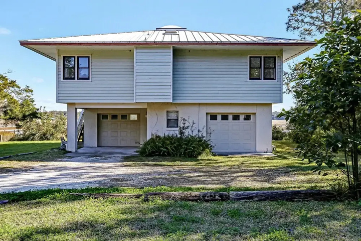 Exterior of Open Floor Home with Marsh Front Deck and Breathtaking View by RedAwning